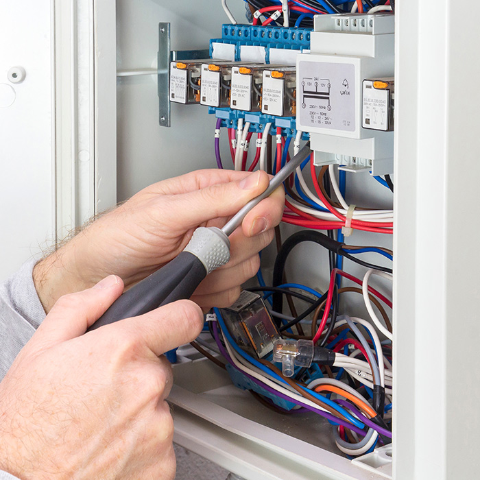 electrician-hand-with-screwdriver-upgrading-electrical-panel-auburn-ca