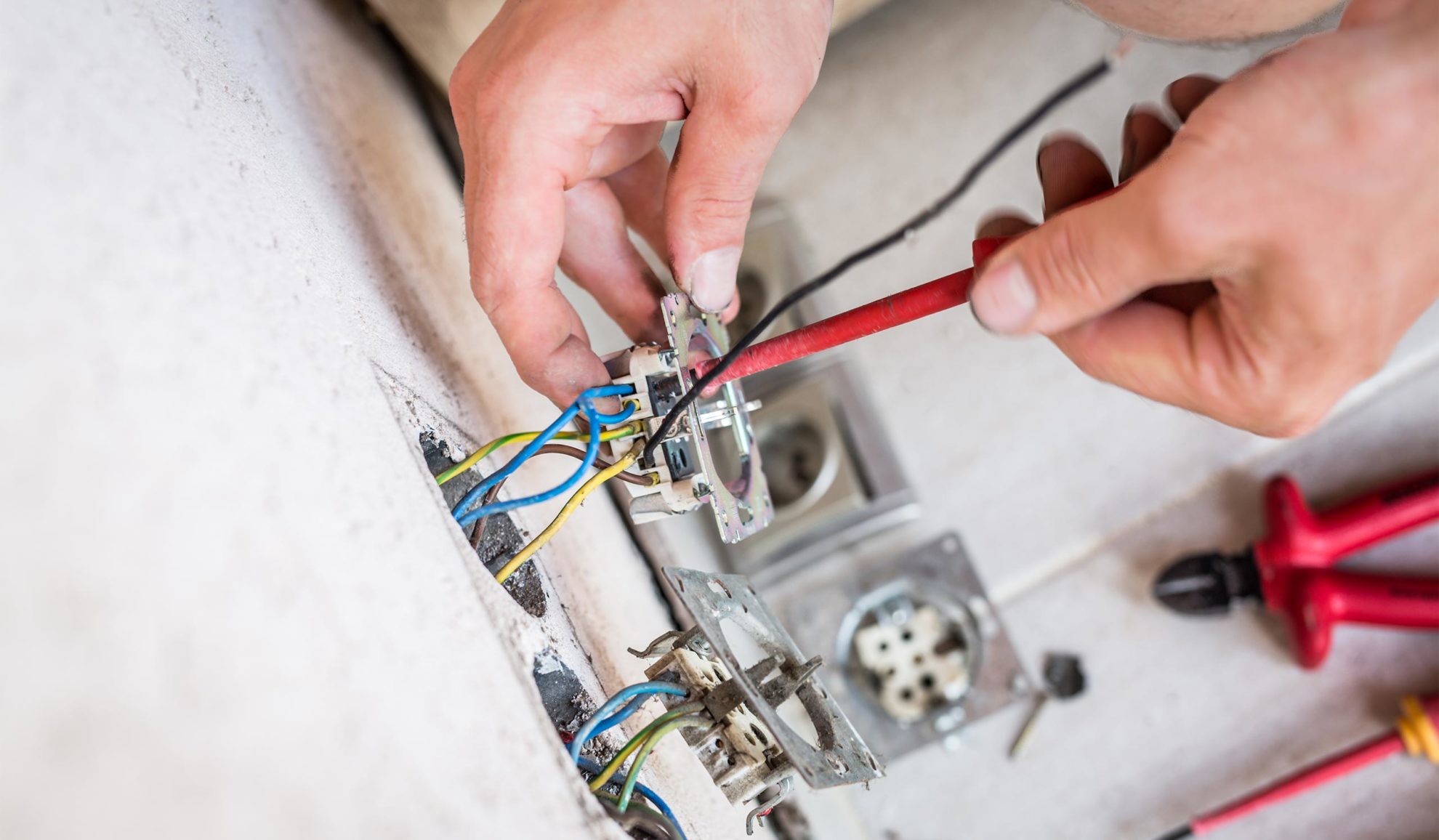 electrician-hands-close-up-installing-new-outlet-at-property-wall-auburn-ca