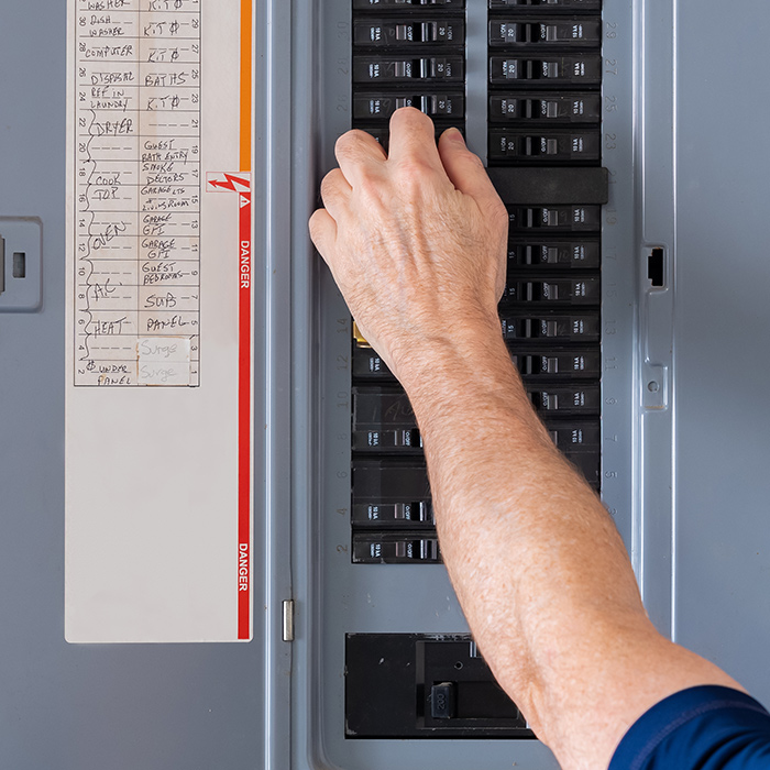 man-hand-using-breakers-from-electrical-panel-auburn-ca